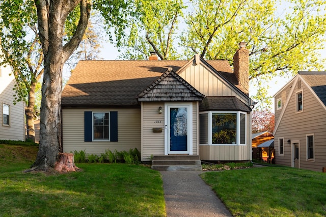1938 Saunders Ave, Saint Paul, MN 55116 - bungalow with board and batten siding, a chimney, and a front lawn