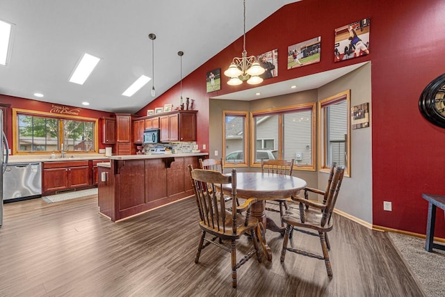 29107 Danel Ave, Randolph, MN 55065 - dining room with high vaulted ceiling, wood finished floors, a chandelier, and baseboards