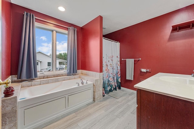 29107 Danel Ave, Randolph, MN 55065 - bathroom featuring a bath, wood finished floors, a shower with shower curtain, vanity, and recessed lighting