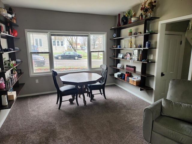 carpeted dining space with baseboards