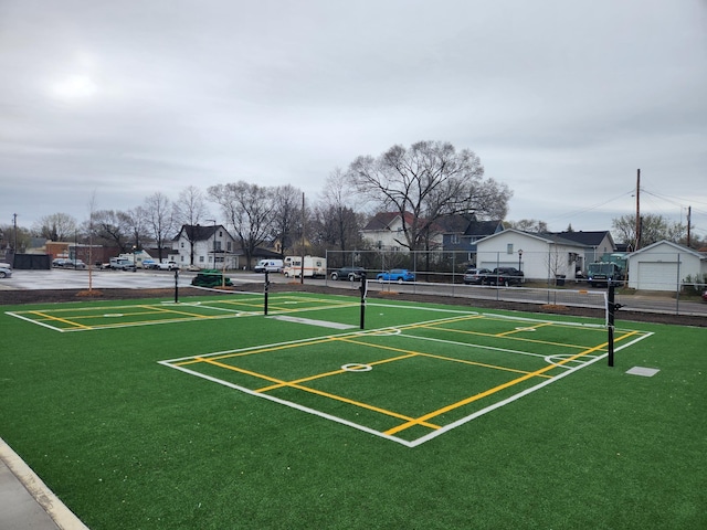 view of community with a sport area, fence, and a residential view