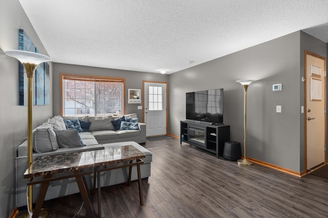 living area featuring baseboards, a textured ceiling, and dark wood-style flooring