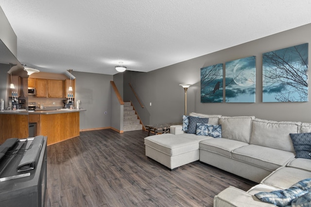 living room featuring baseboards, a textured ceiling, dark wood-type flooring, and stairway