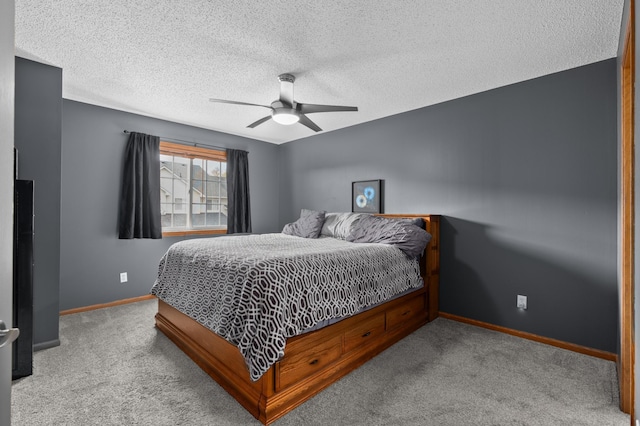 carpeted bedroom with baseboards, a textured ceiling, and ceiling fan