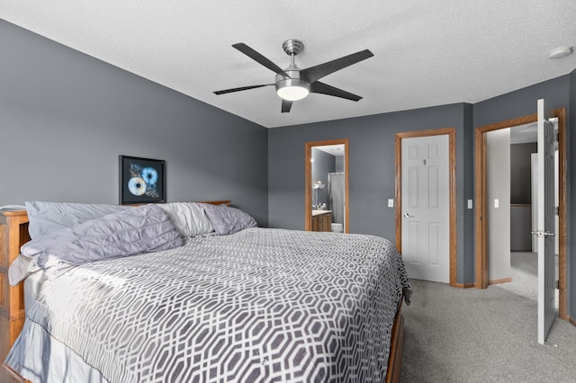 bedroom featuring a ceiling fan, baseboards, a textured ceiling, carpet flooring, and ensuite bathroom