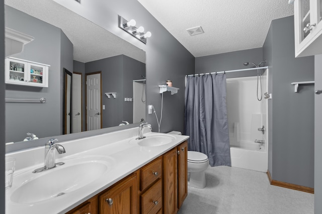 bathroom with a textured ceiling, toilet, shower / bath combo, and a sink