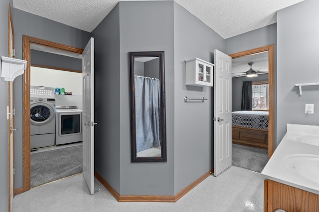 full bath featuring ensuite bath, washer and clothes dryer, baseboards, and a textured ceiling