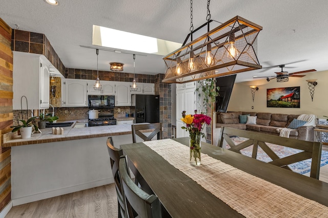 1302 Birch Dr, Hudson, WI 54016 - dining space with light wood finished floors, ceiling fan, and a textured ceiling