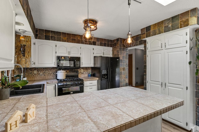 1302 Birch Dr, Hudson, WI 54016 - kitchen featuring black appliances, a sink, a peninsula, white cabinets, and decorative backsplash