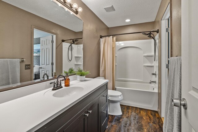 1302 Birch Dr, Hudson, WI 54016 - full bathroom with wood finished floors, shower / tub combo, toilet, vanity, and a textured ceiling