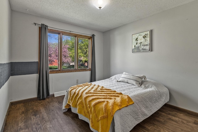 1302 Birch Dr, Hudson, WI 54016 - bedroom featuring dark wood finished floors, a textured ceiling, and baseboards