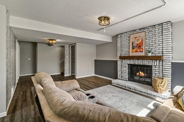 1302 Birch Dr, Hudson, WI 54016 - living area featuring a textured ceiling, wood finished floors, a fireplace, and baseboards
