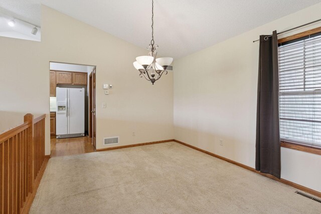 2117 14th St NE, Faribault, MN 55021 - unfurnished room featuring light carpet, a chandelier, and lofted ceiling