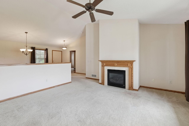2117 14th St NE, Faribault, MN 55021 - unfurnished living room with a ceiling fan, carpet, a chandelier, a glass covered fireplace, and lofted ceiling