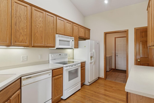 2117 14th St NE, Faribault, MN 55021 - kitchen with white appliances, light countertops, light wood-style floors, and brown cabinetry