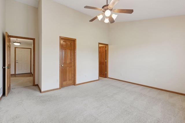 2117 14th St NE, Faribault, MN 55021 - unfurnished bedroom with light colored carpet, high vaulted ceiling, and ceiling fan