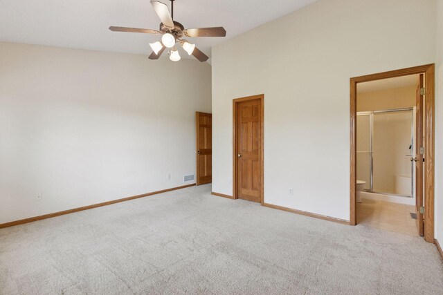 2117 14th St NE, Faribault, MN 55021 - unfurnished bedroom with light colored carpet, high vaulted ceiling, connected bathroom, and a ceiling fan