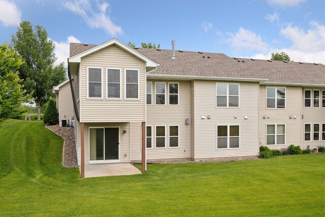 2117 14th St NE, Faribault, MN 55021 - rear view of property featuring a yard, a patio, and a shingled roof