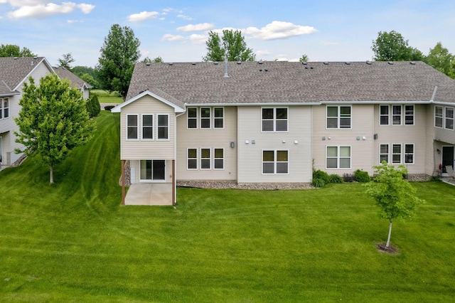 2117 14th St NE, Faribault, MN 55021 - back of property with a patio, a yard, and a shingled roof