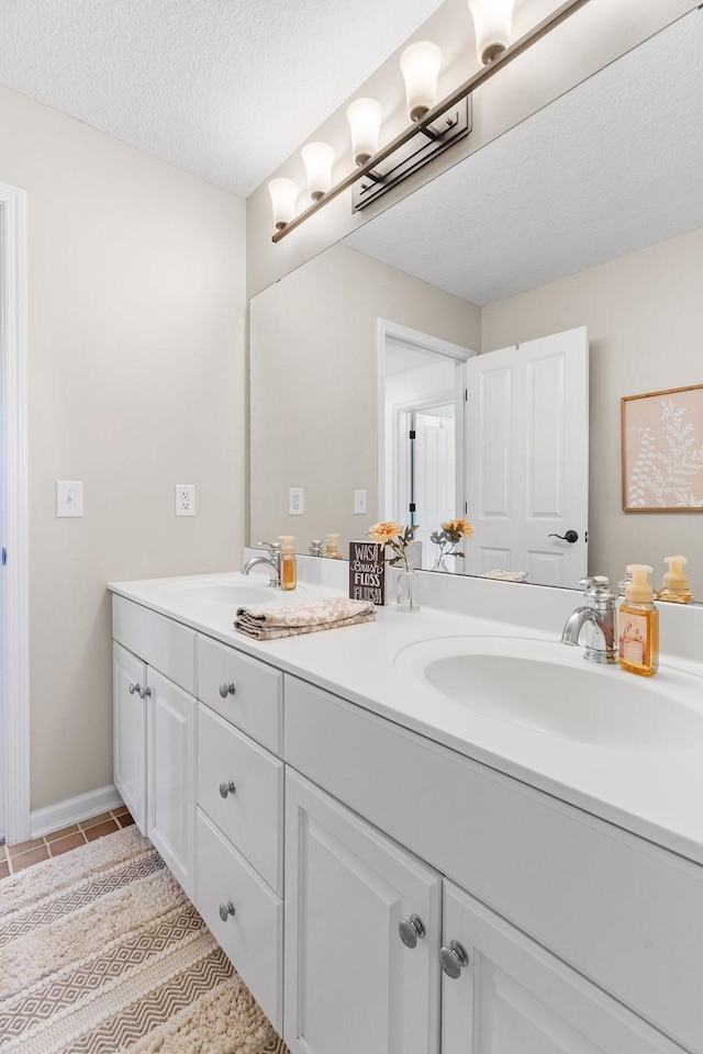 5761 Sunnybrook Ln, Minnetrista, MN 55364 - bathroom with double vanity, tile patterned flooring, and a textured ceiling