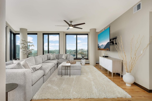 1240 2nd St Unit 701, Minneapolis, MN 55415 - living room featuring light wood-type flooring, a ceiling fan, and baseboards