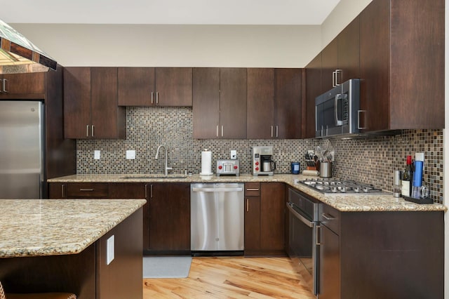 1240 2nd St Unit 701, Minneapolis, MN 55415 - kitchen featuring stainless steel appliances, a sink, light wood finished floors, and dark brown cabinets