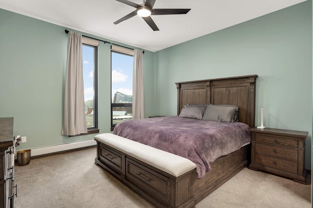1240 2nd St Unit 701, Minneapolis, MN 55415 - bedroom with light carpet, baseboard heating, baseboards, and ceiling fan