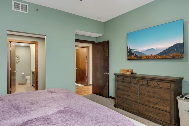 1240 2nd St Unit 701, Minneapolis, MN 55415 - bedroom featuring connected bathroom and light colored carpet
