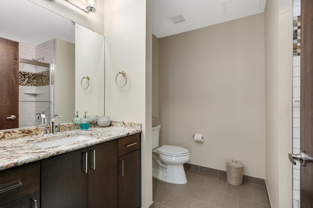 1240 2nd St Unit 701, Minneapolis, MN 55415 - bathroom with tile patterned floors, toilet, vanity, a stall shower, and baseboards