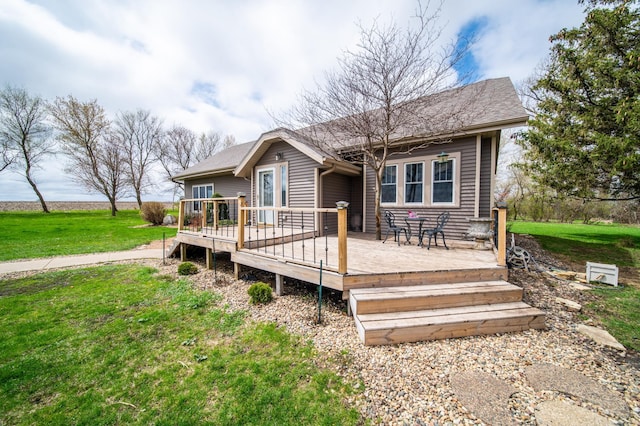 back of property with a lawn and a wooden deck