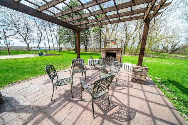 view of patio / terrace with an outdoor stone fireplace, a trampoline, and a pergola