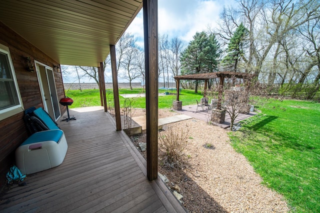 wooden deck featuring a yard and a patio