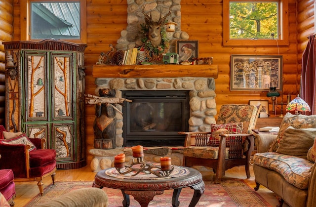51641 Edgewater Rd, Spring Lake, MN 56680 - living room featuring log walls, wood finished floors, and a stone fireplace