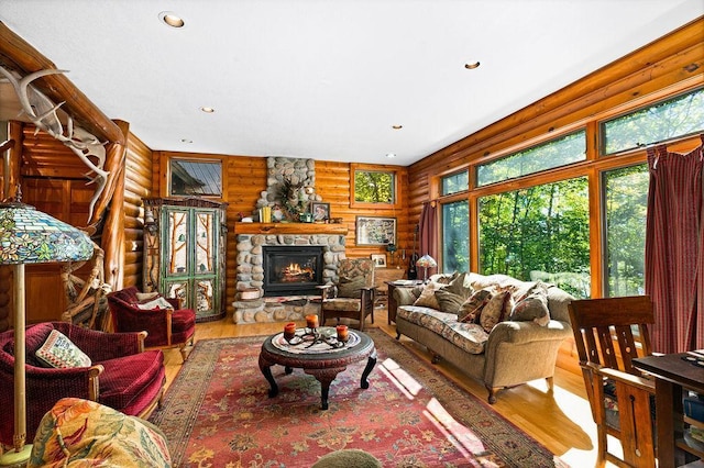 51641 Edgewater Rd, Spring Lake, MN 56680 - living room with log walls, wood finished floors, recessed lighting, and a fireplace