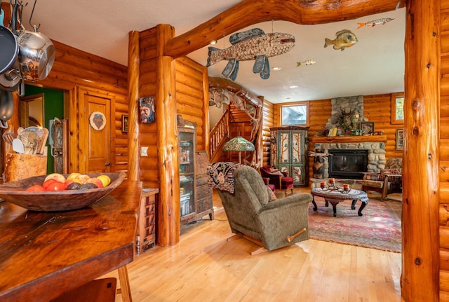 51641 Edgewater Rd, Spring Lake, MN 56680 - living room featuring rustic walls, stairway, hardwood / wood-style flooring, and a fireplace