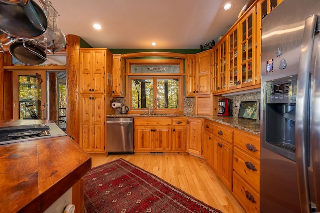 51641 Edgewater Rd, Spring Lake, MN 56680 - kitchen with appliances with stainless steel finishes, light wood-type flooring, a sink, recessed lighting, and decorative backsplash