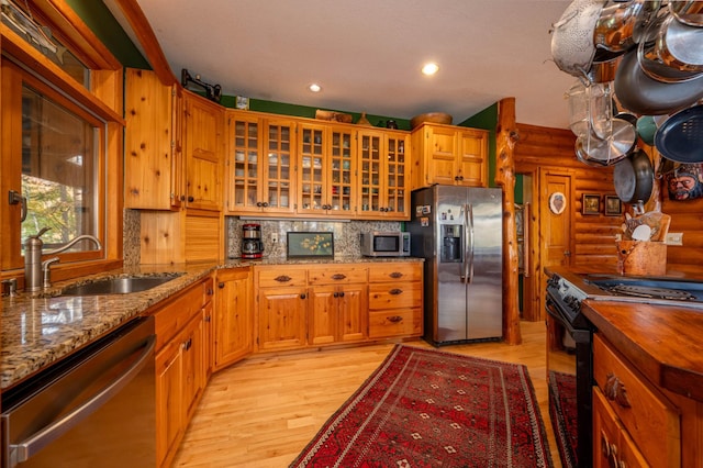 51641 Edgewater Rd, Spring Lake, MN 56680 - kitchen with stainless steel appliances, a sink, rustic walls, light wood-style floors, and light stone countertops