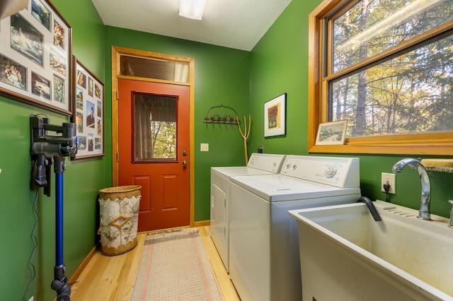51641 Edgewater Rd, Spring Lake, MN 56680 - laundry area with washer and dryer, light wood-style floors, and baseboards