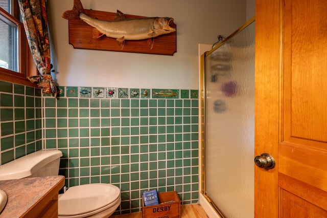 51641 Edgewater Rd, Spring Lake, MN 56680 - full bath featuring tile walls, a shower stall, toilet, vanity, and a wainscoted wall