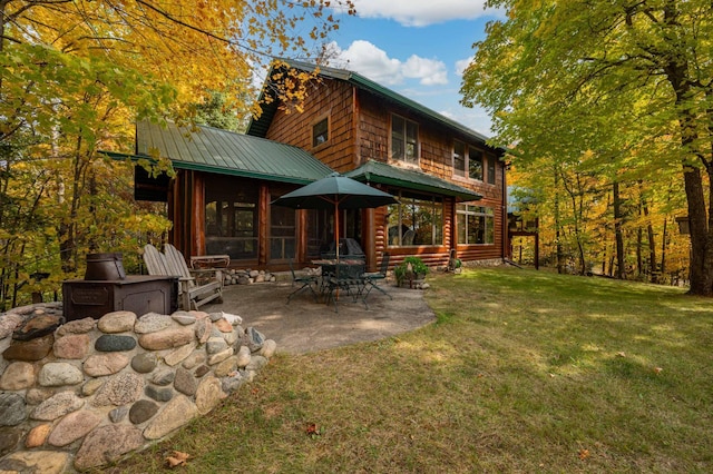 51641 Edgewater Rd, Spring Lake, MN 56680 - back of property featuring a lawn, metal roof, and a patio area