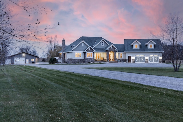 view of front of house with a garage, a front yard, and stone siding