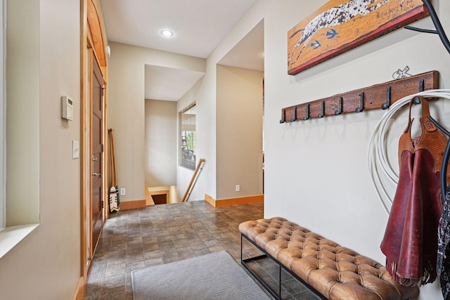 mudroom with baseboards, recessed lighting, and stone finish flooring
