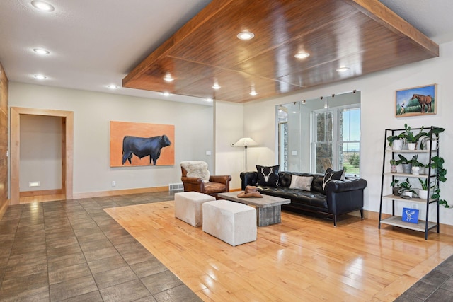living room with wood-type flooring, recessed lighting, and baseboards