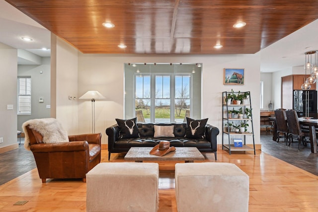 living area with recessed lighting, light wood finished floors, baseboards, and wooden ceiling