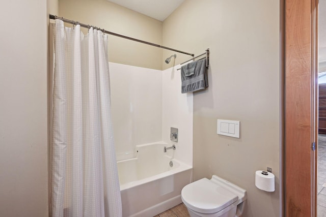 full bathroom featuring shower / bath combo with shower curtain and toilet