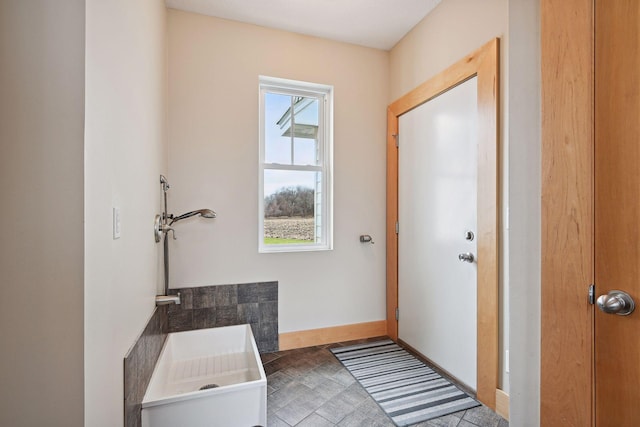 doorway featuring baseboards