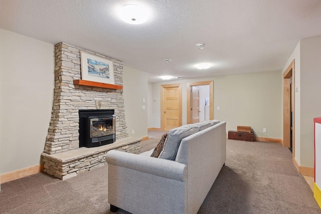 carpeted living room featuring baseboards, a fireplace, and a textured ceiling