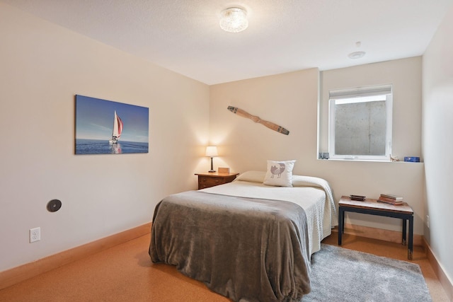 carpeted bedroom featuring baseboards