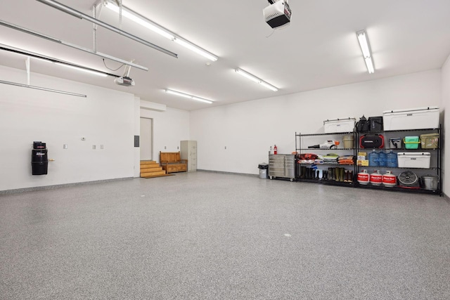 garage featuring baseboards and a garage door opener