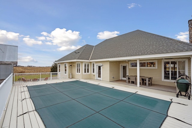 view of swimming pool with a fenced in pool and a wooden deck